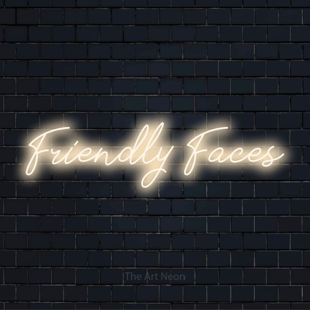 "Friendly Faces" neon text design on a black brick wall