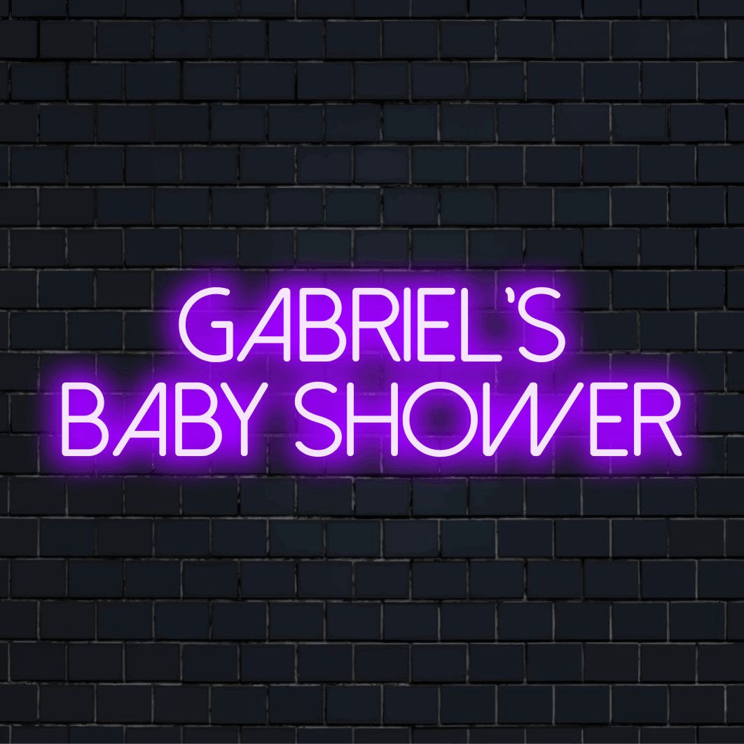Gabriel_s Baby Shower Custom Name Neon Sign, glowing wall decor on dark brick wall