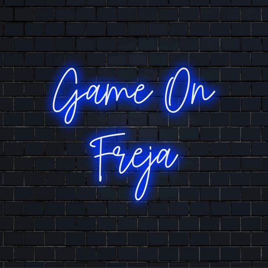 Game On Freja Personalized Neon Light with glowing wall decor against black brick wall