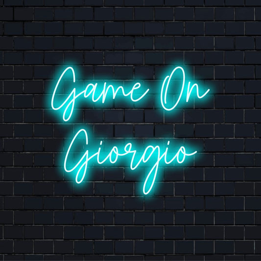 Game On Giorgio Custom Name Neon Sign, soft neon glow against black brick wall