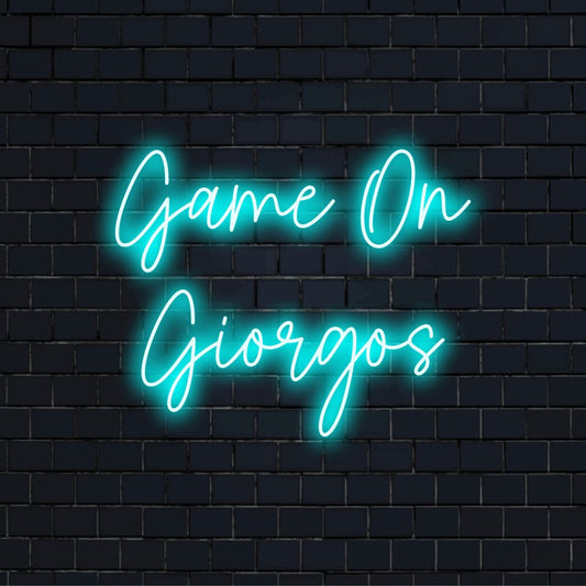 Game On Giorgos Custom Name Neon Sign, bright neon lettering on black brick background