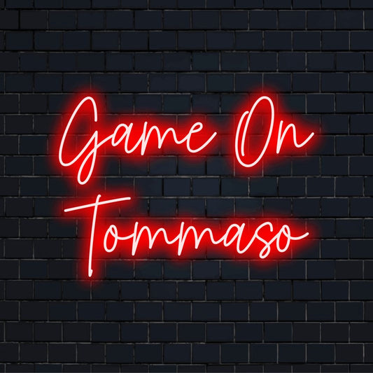 Game On Tommaso Personalized LED Neon Sign, glowing lettering against brick backdrop