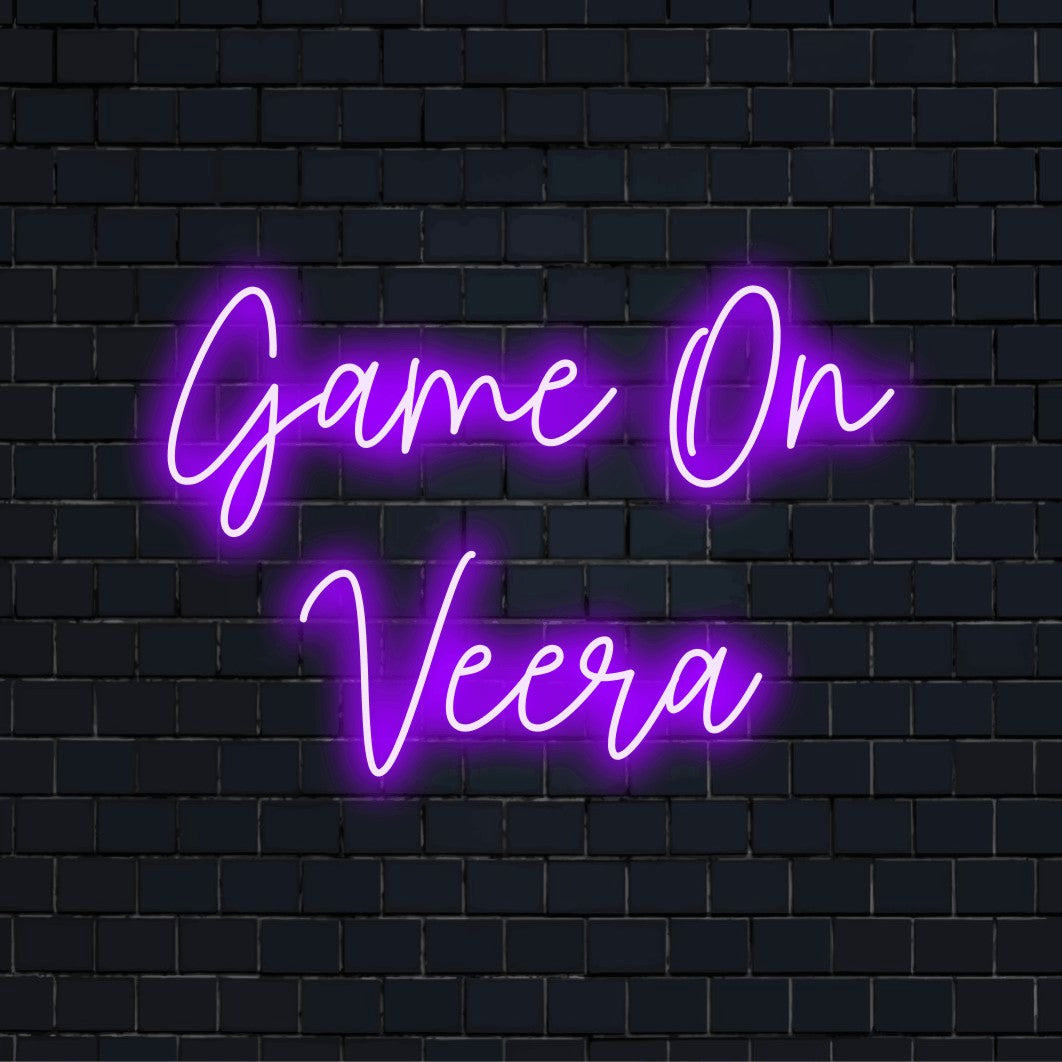 Game On Veera Personalized Neon Light with glowing wall decor against black brick wall