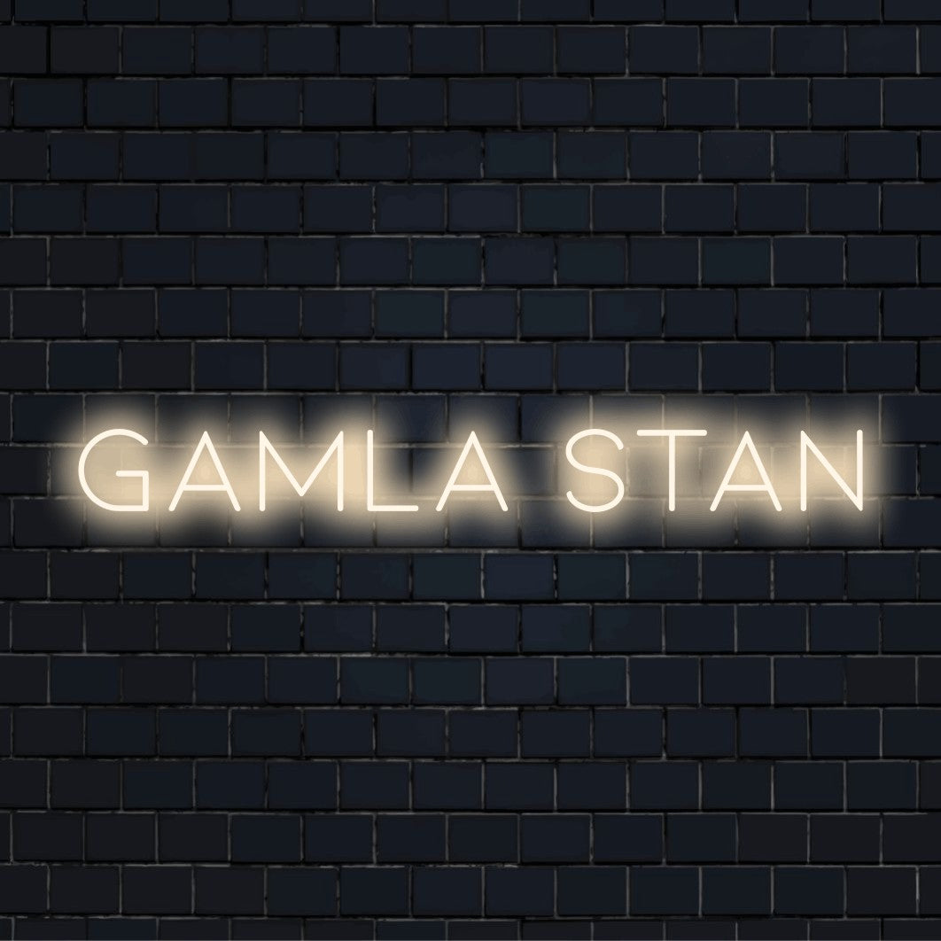 Gamla Stan Neon Sign, bright neon lettering on black brick background