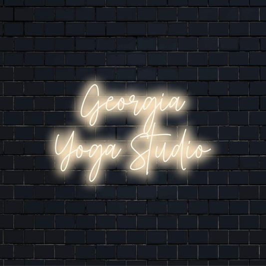 Georgia Yoga Studio Personalized LED Neon Sign, glowing lettering on black brick background