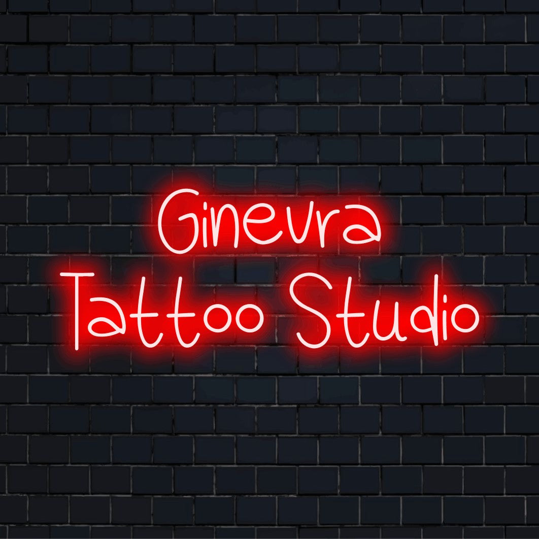 Ginevra Tattoo Studio Personalized Neon Light with glowing neon text against black brick wall