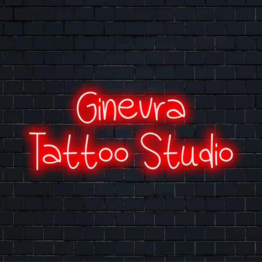 Ginevra Tattoo Studio Personalized Neon Light with glowing neon text against black brick wall
