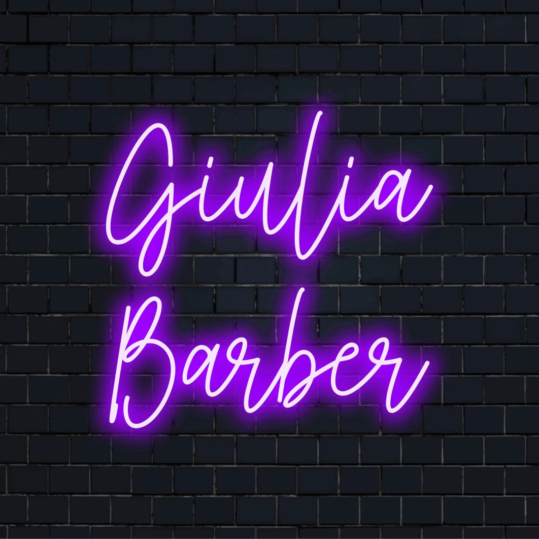 Giulia Barber Custom Name Neon Sign, bright LED glow against black brick wall