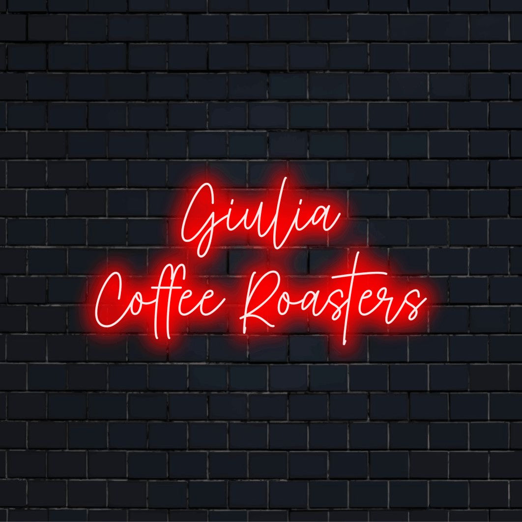 Giulia Coffee Roasters Personalized Neon Light with soft neon glow on dark brick background