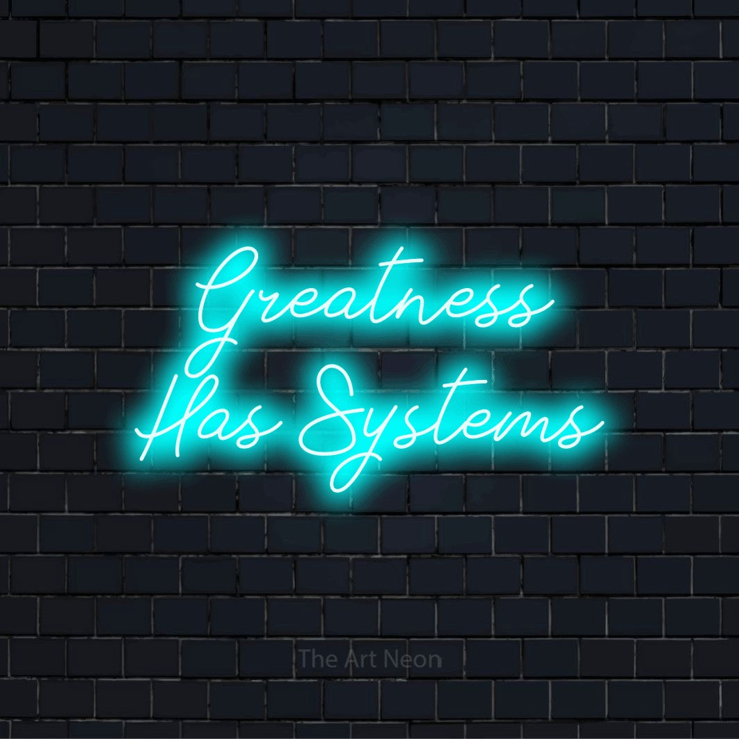 "Greatness Has Systems" glowing LED neon sign on a black brick wall