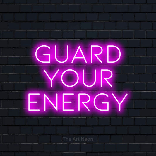 "Guard Your Energy" neon text design on a black brick wall