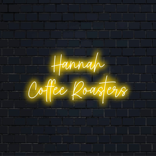 Hannah Coffee Roasters Custom Name Neon Sign, bright neon glow against black brick wall