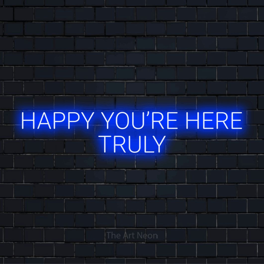 "Happy You’re Here Truly" LED neon sign on a black brick wall
