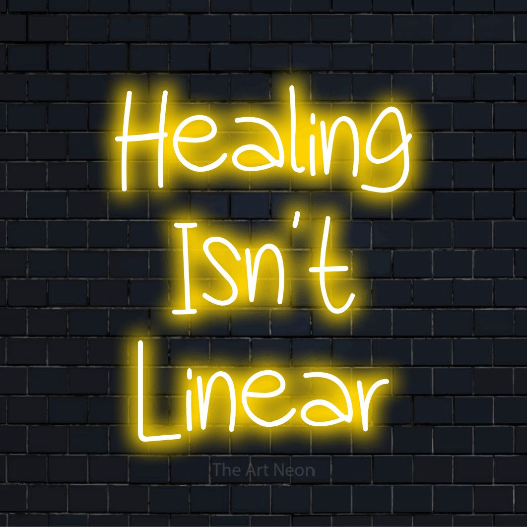 "Healing Isn’t Linear" text design with neon effect on a black brick wall