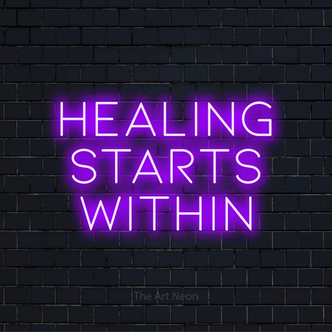 "Healing Starts Within" text design with neon effect on a black brick wall