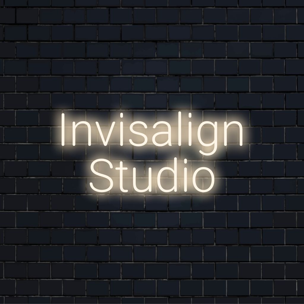 Invisalign Studio LED Neon Sign, bright neon glow against brick backdrop
