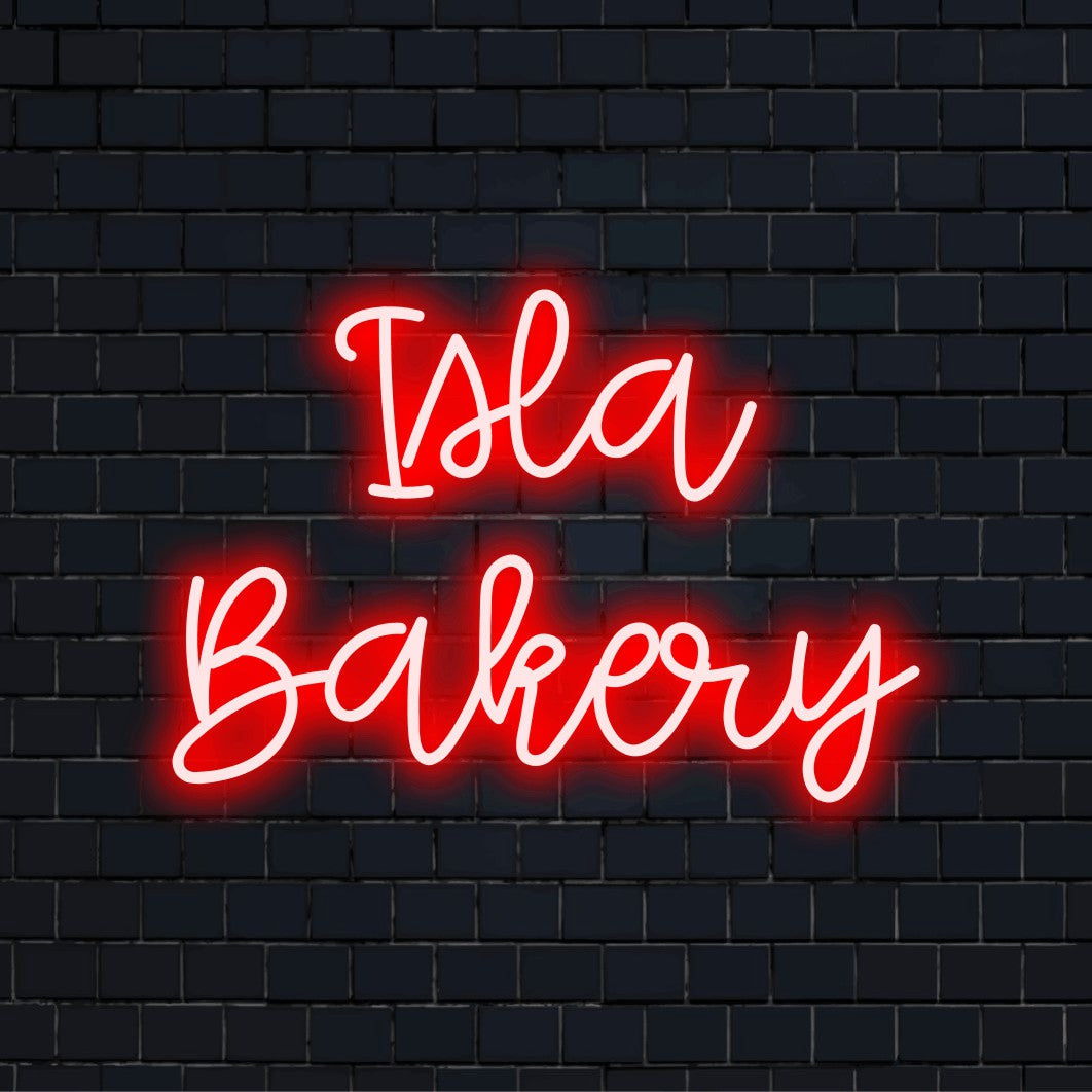 Isla Bakery Personalized LED Neon Sign, glowing wall decor against black brick wall