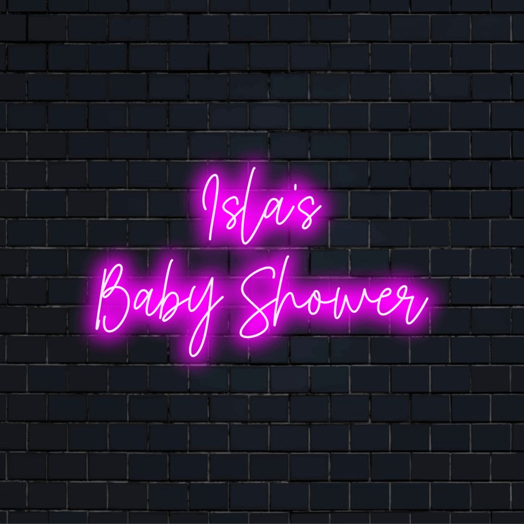 Isla_s Baby Shower Custom Name Neon Sign, bright neon lettering against black brick wall