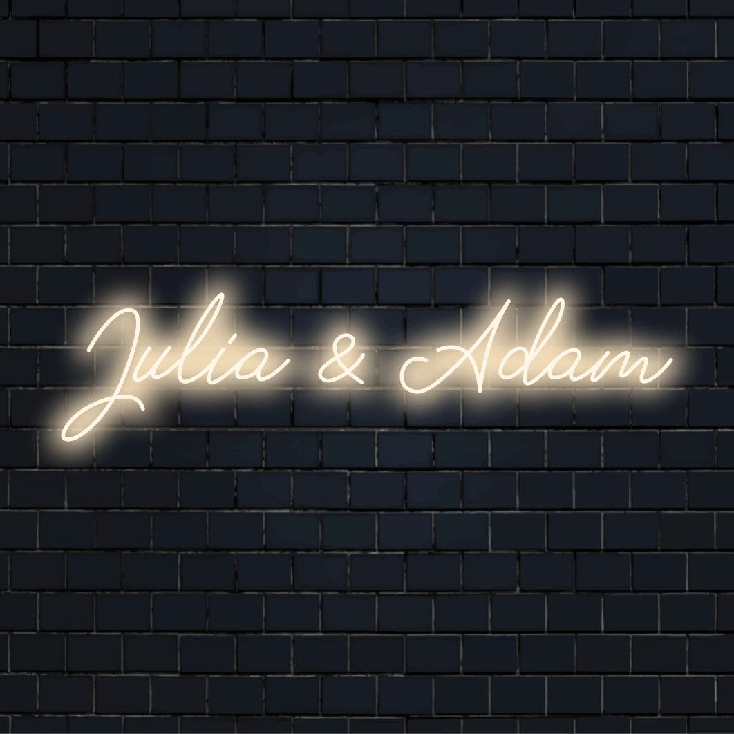 Julia _ Adam Custom Name Neon Sign, bright neon glow on dark brick wall