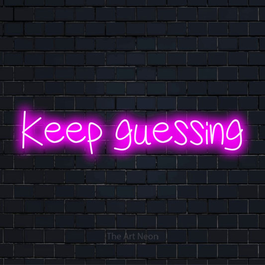 "Keep Guessing" script-style LED neon sign on a black brick wall