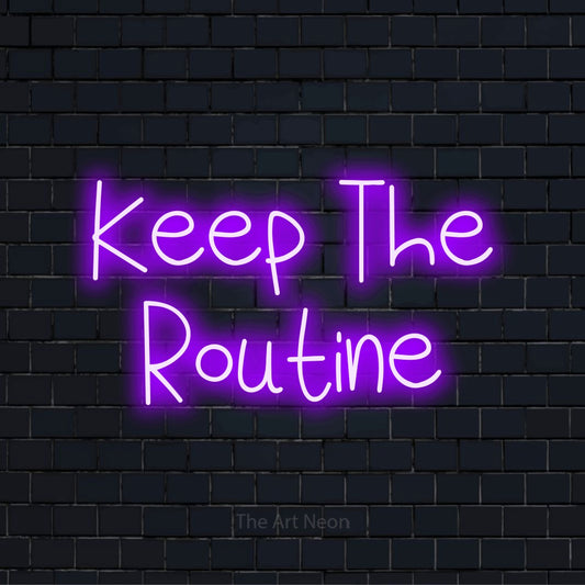 "Keep The Routine" script-style LED neon sign on a black brick wall