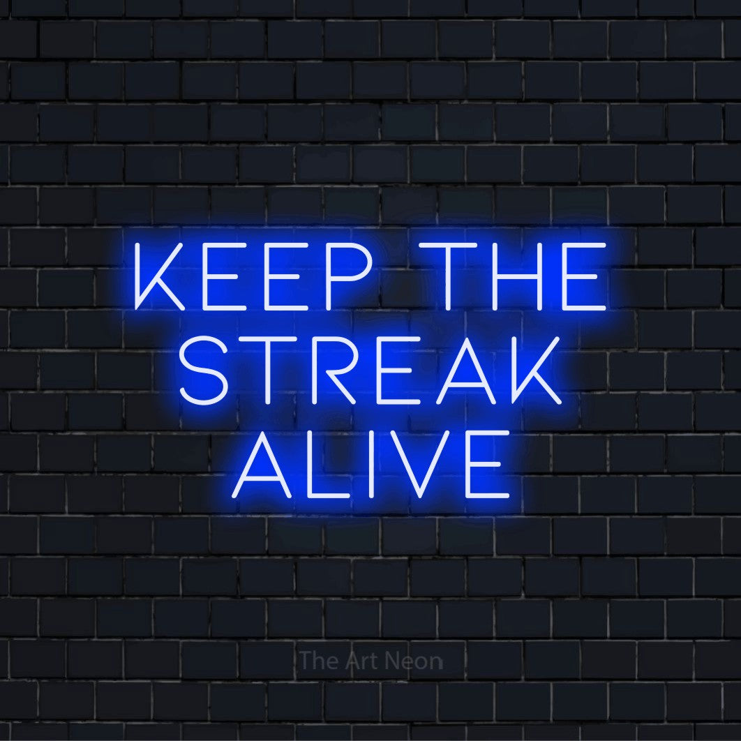 "Keep The Streak Alive" neon text design on a black brick wall