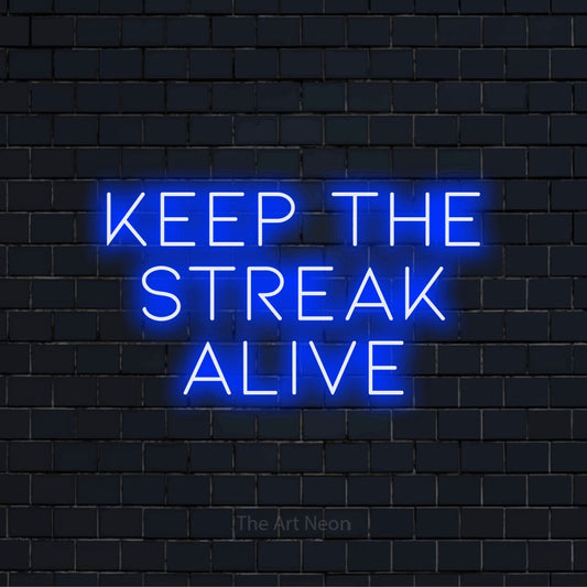 "Keep The Streak Alive" neon text design on a black brick wall