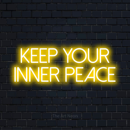 "Keep Your Inner Peace" glowing LED neon sign on a black brick wall