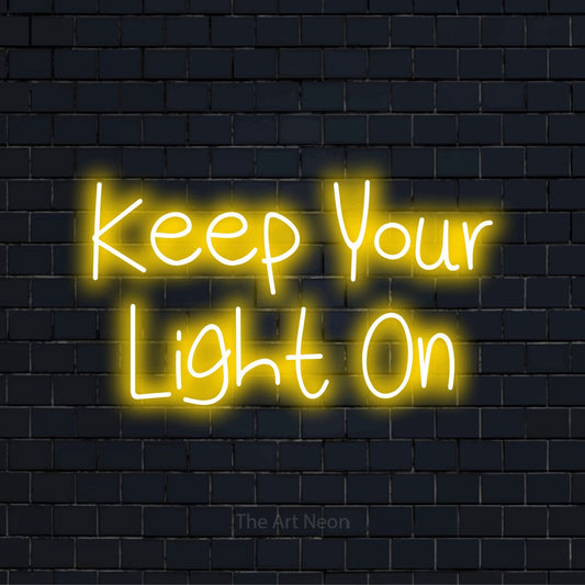 "Keep Your Light On" neon text design on a black brick wall