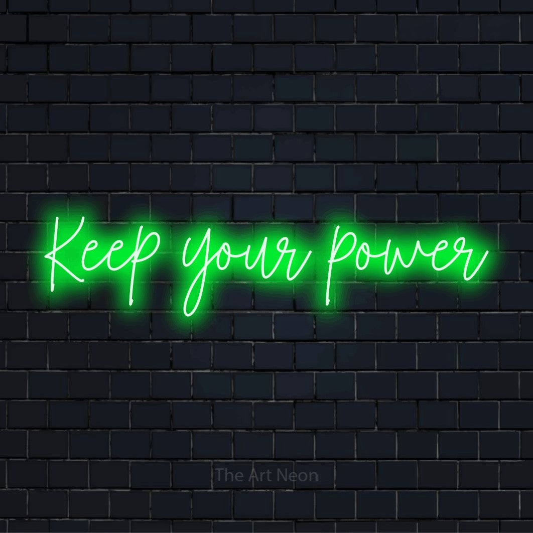 "Keep Your Power" glowing LED neon sign on a black brick wall