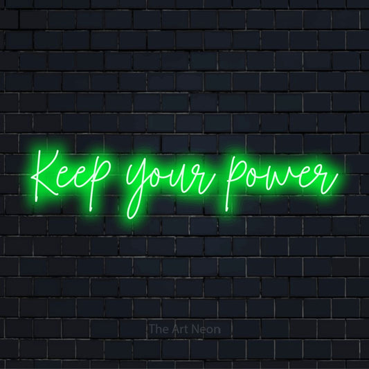 "Keep Your Power" glowing LED neon sign on a black brick wall