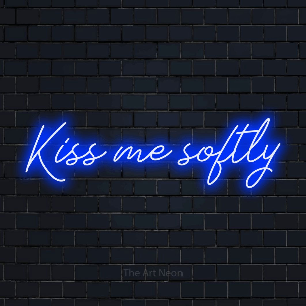 "Kiss Me Softly" glowing LED neon sign on a black brick wall