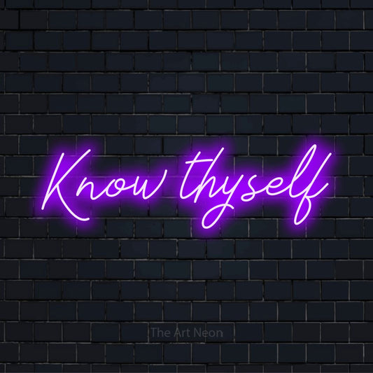 "Know Thyself" LED neon sign on a black brick wall