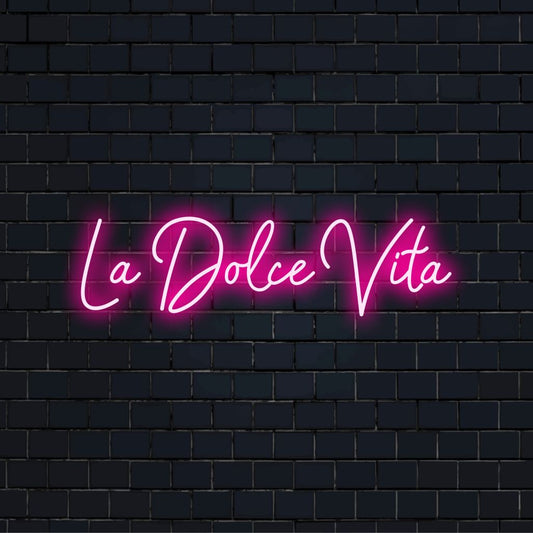 La Dolce Vita Neon Sign, neon text light against brick backdrop