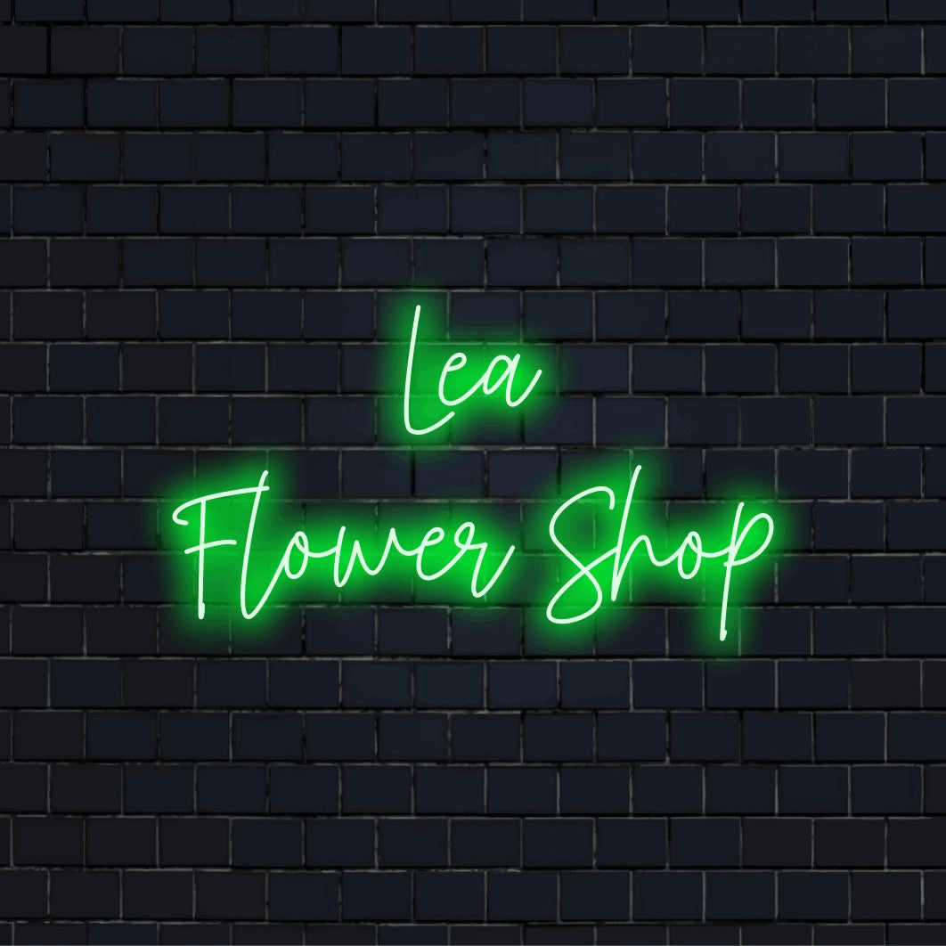 Lea Flower Shop Personalized LED Neon Sign, glowing lettering on dark brick wall