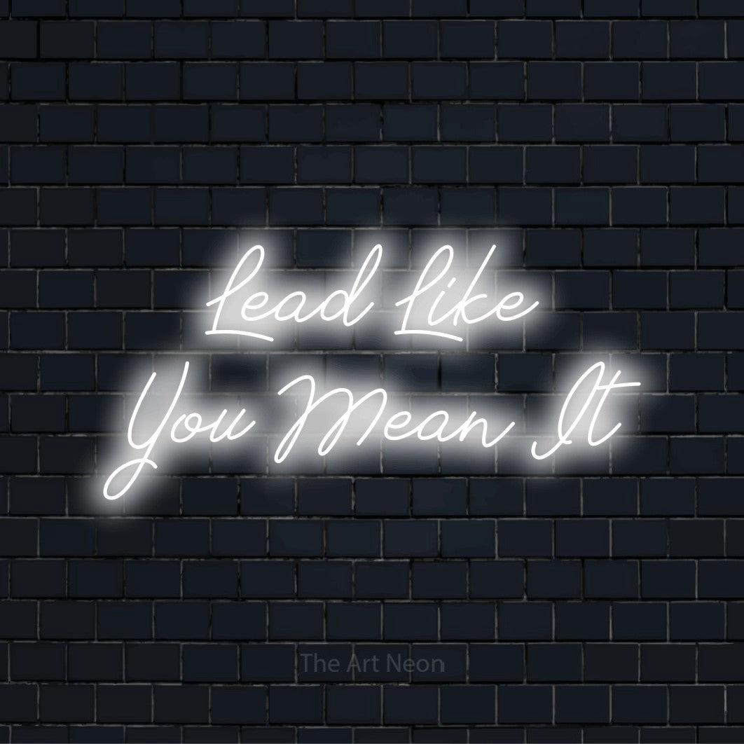 "Lead Like You Mean It" LED neon sign on a black brick wall