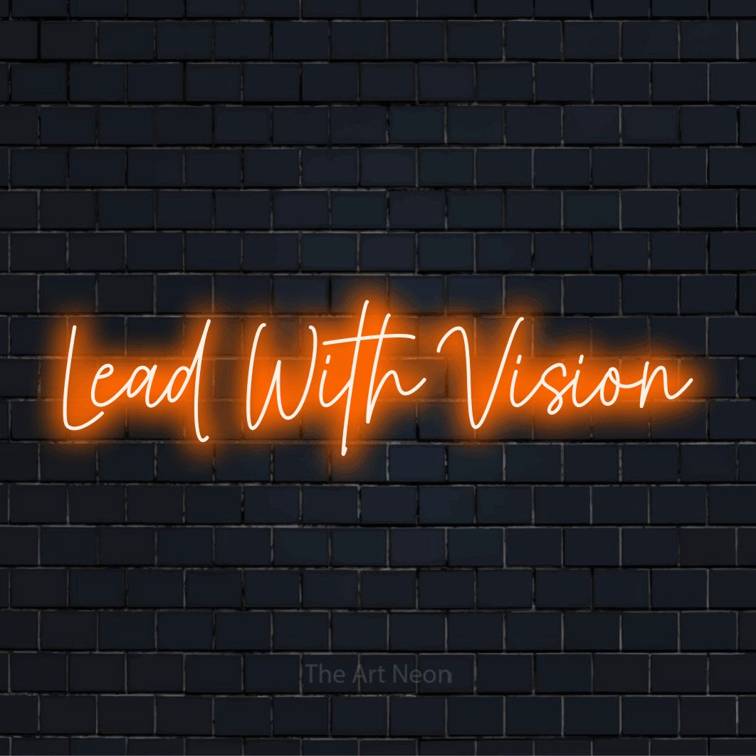 "Lead With Vision" script-style LED neon sign on a black brick wall