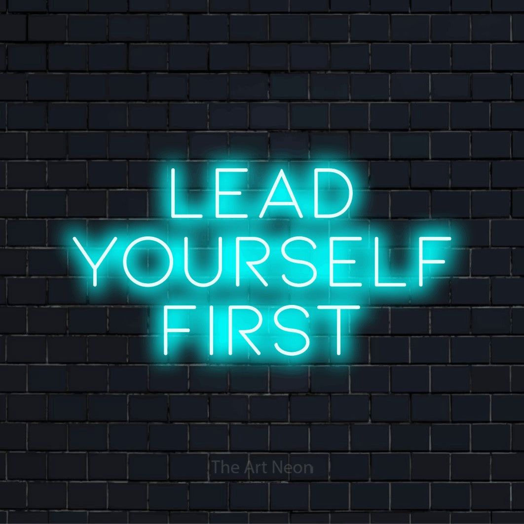 "Lead Yourself First" LED neon sign on a black brick wall