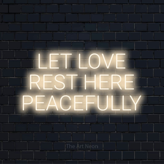 "Let Love Rest Here Peacefully" LED neon sign on a black brick wall