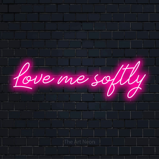 "Love Me Softly" text design with neon effect on a black brick wall