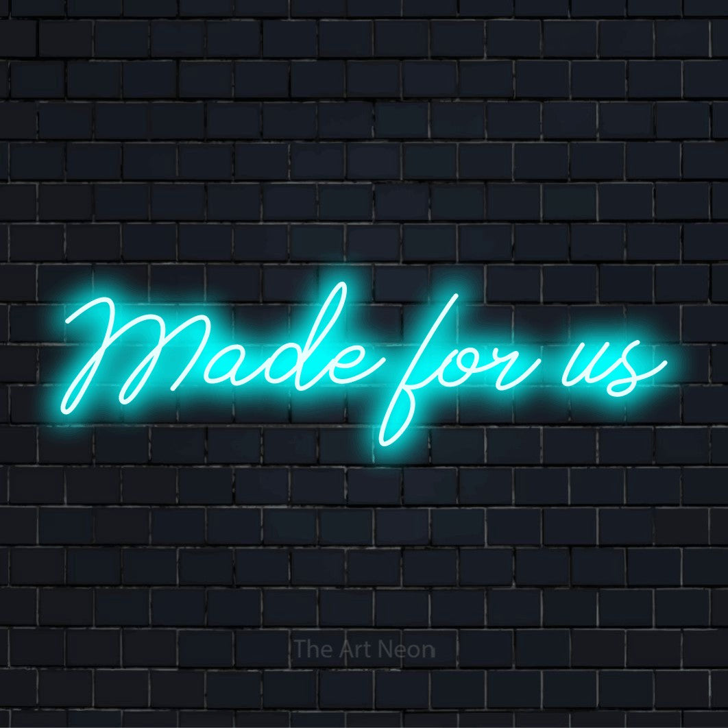"Made For Us" neon text design on a black brick wall
