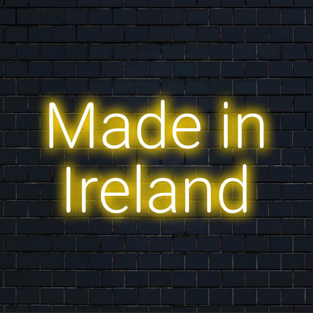 Made In Ireland LED Neon Sign, glowing lettering on dark brick wall