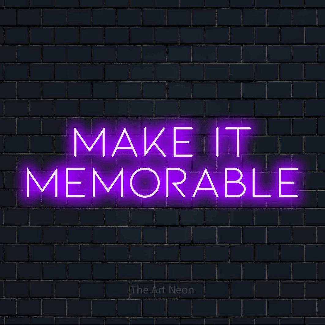 "Make It Memorable" LED neon sign on a black brick wall