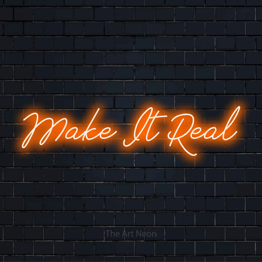 "Make It Real" LED neon sign on a black brick wall