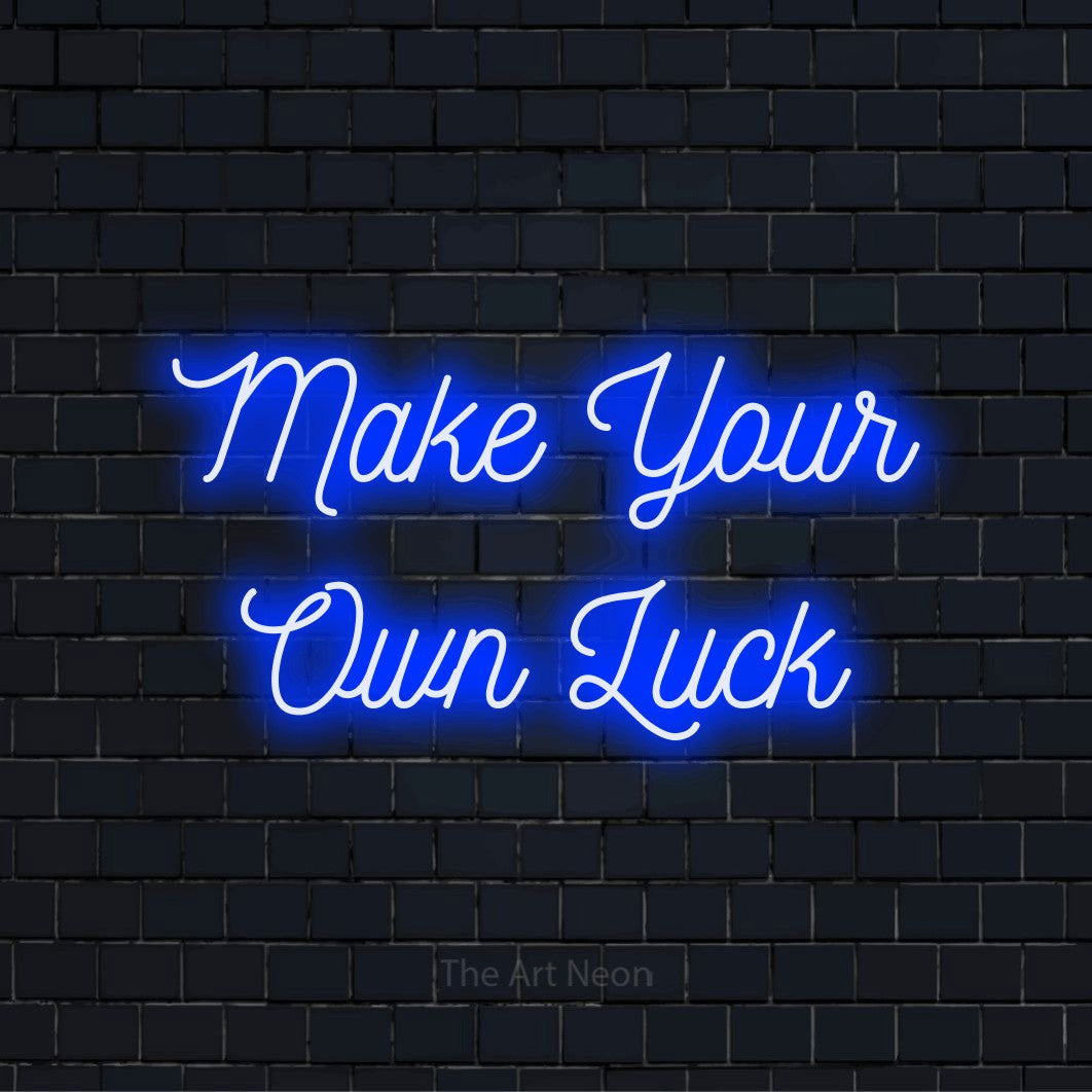 "Make Your Own Luck" neon text design on a black brick wall