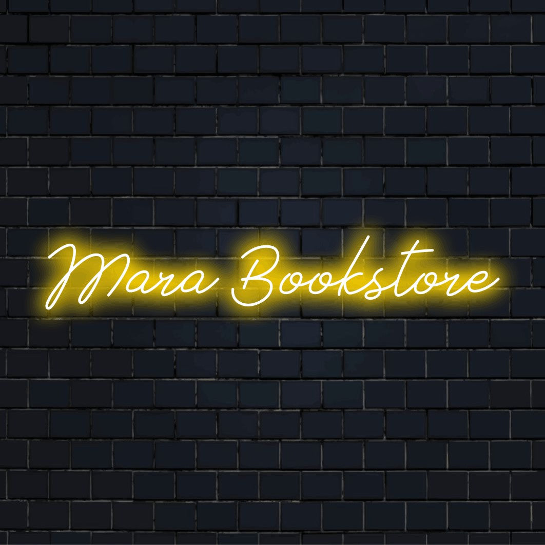 Mara Bookstore Personalized Neon Light with soft neon glow against black brick wall