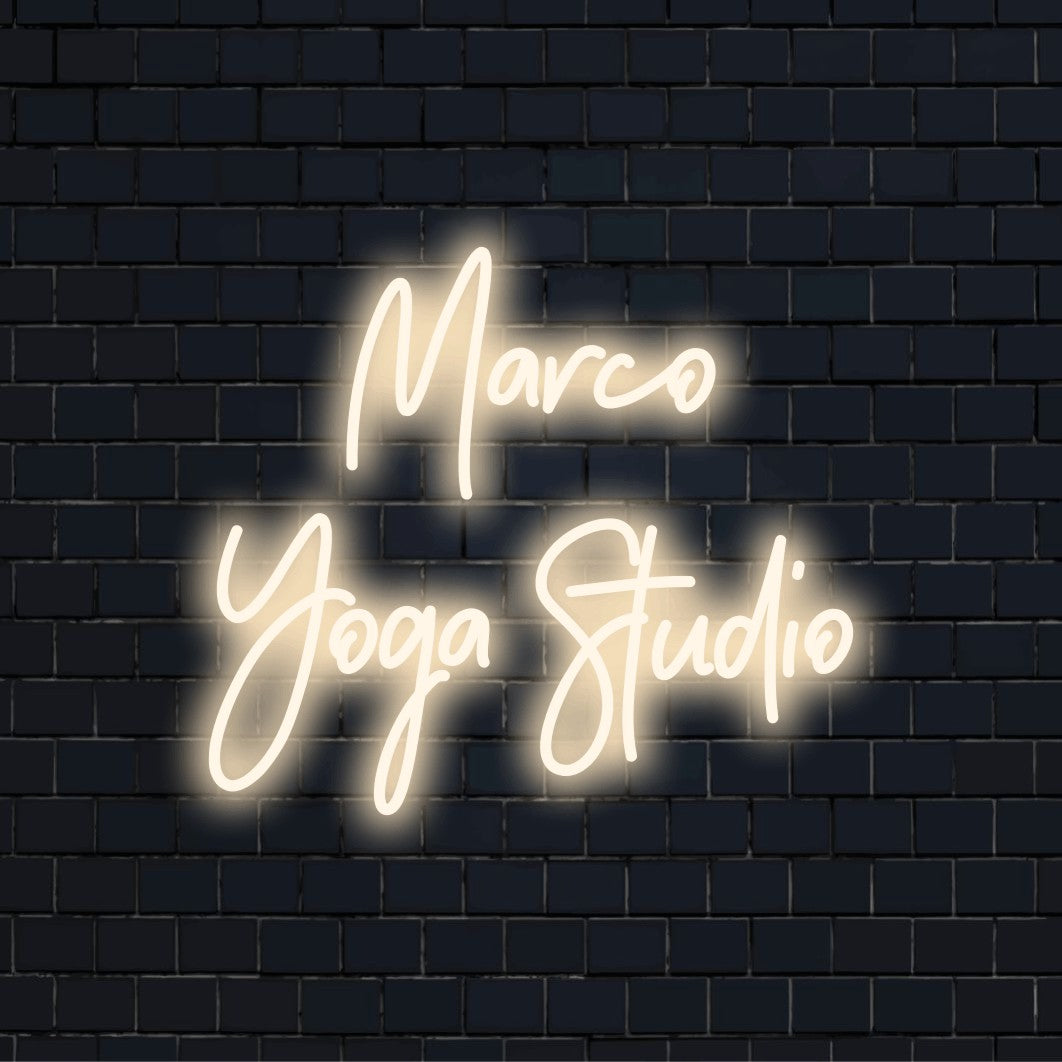 Marco Yoga Studio Custom Name Neon Sign, bright neon lettering on dark brick background