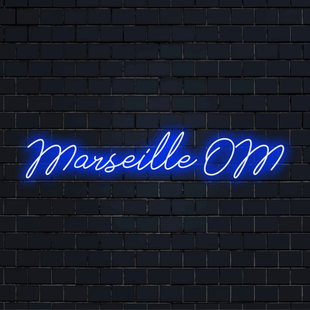 Marseille Om Neon Light with bright LED glow on dark brick wall