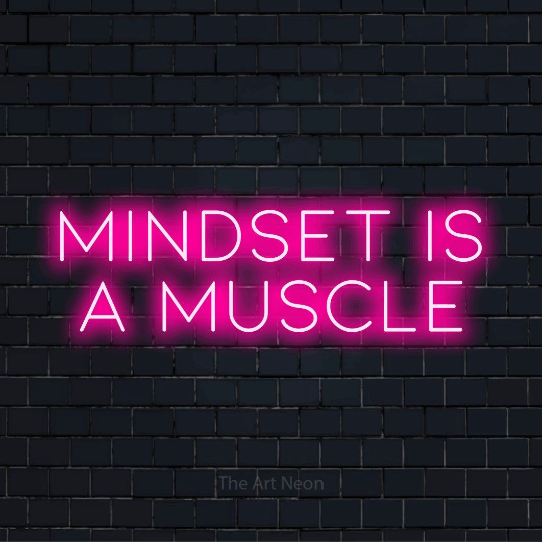 "Mindset Is A Muscle" neon text design on a black brick wall