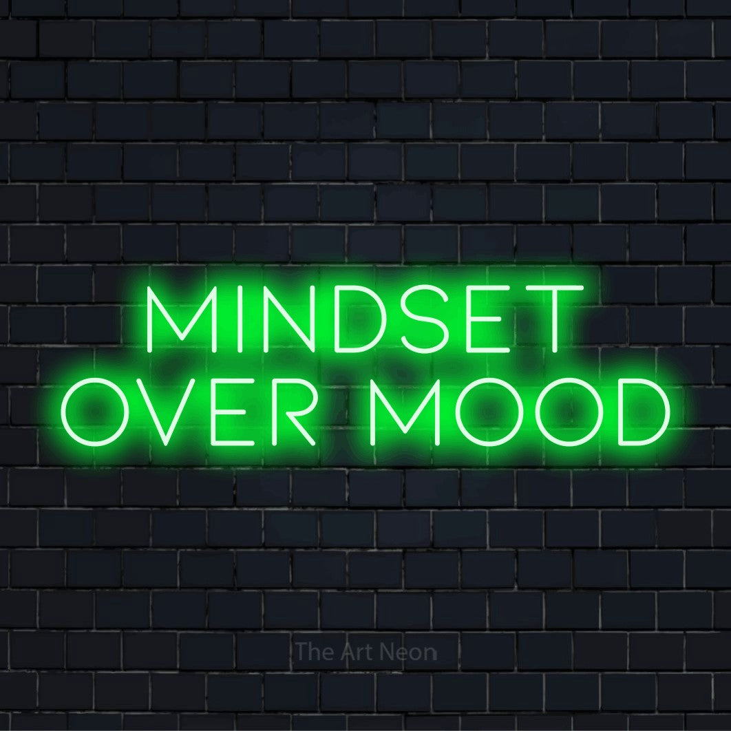 "Mindset Over Mood" script-style LED neon sign on a black brick wall